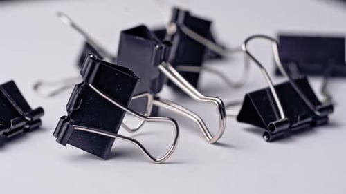 Pile of metal binder clips. Office supplies