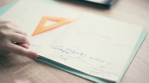 CU: Boy Sit in Headphones and Do School Homework, Flips Through the Page in the Notebook