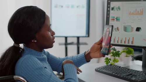Woman in Wheelchair on Video Call in Office