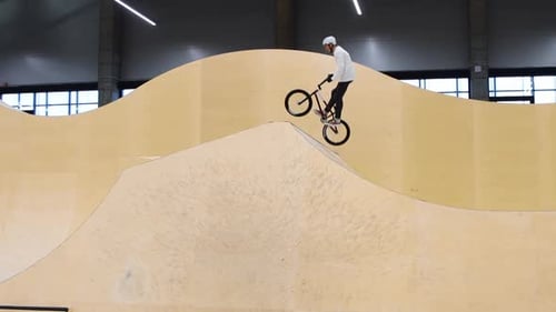 BMX Sports a Man Riding on the Springboards on the Training Ground