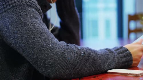 Young Adult Using Tablet Listening to Headphones