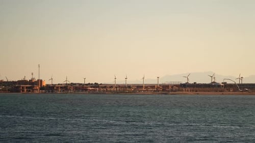 Wind turbines on the coast. View from the sea from the ship