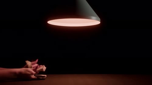 Counting Money Under Warm Light at Night