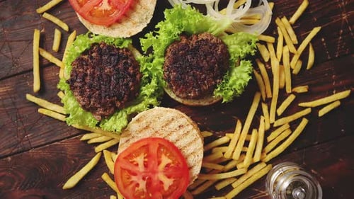 Two Tasty Grilled Home Made Burgers with Beef, Tomato, Onion and Lettuce