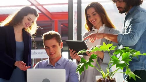 Business executives using laptop and digital tablet