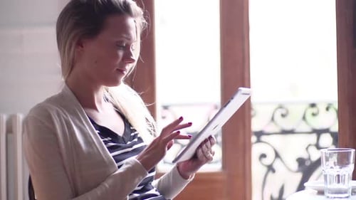 Woman Uses Tablet Indoors During Daytime