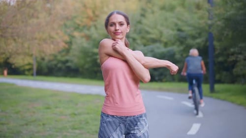 Woman Runner Stretching Arms Before Running Summer Park