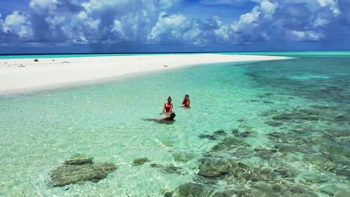 Female models best friends on tropical bay beach time by aqua blue water with white sandy background
