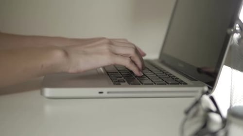 Close Up of Hands Typing on Laptop Keyboard