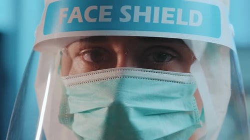 Adult Wearing Protective Gear and Face Shield