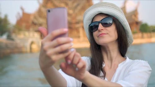 Woman Taking Selfportrait Photo in Front of the Ancient Temple