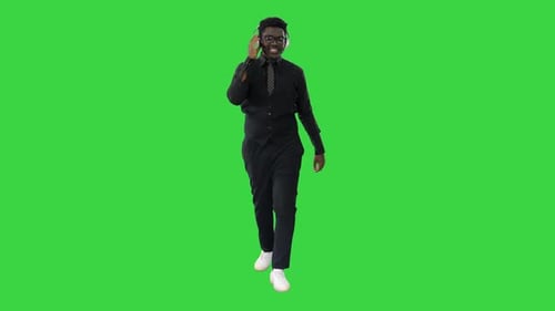 Smiling Man Walking and Listening on Green Screen