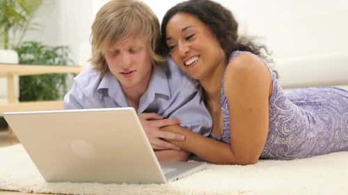 Loving Couple Using Laptop Computer Together at Home
