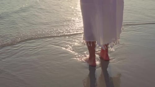 Beautiful female happy relax walking on beach near sea when sunset in evening.