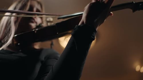 Female Violinist is Playing Violin in Music Hall Beautiful Young Woman with Fiddle