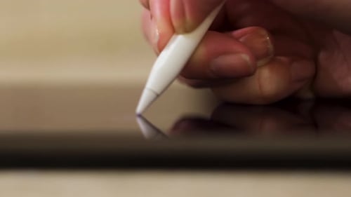 Stylus Being Used on Black Tablet Close Up