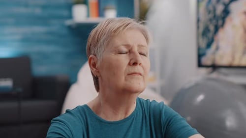 Close Up of Pensioner Closing Eyes and Meditating to Relax