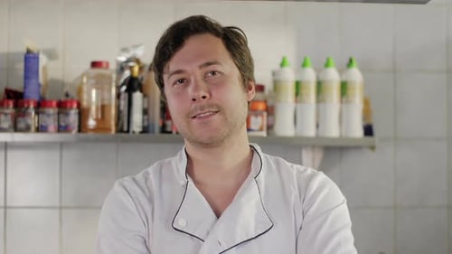 Portrait of a Positive Chef Cook Standing on Kitchen