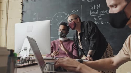 People in Masks Working in Office