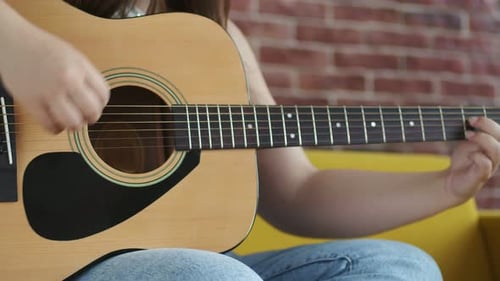 Close-up of Acoustic Guitar Playing Indoors