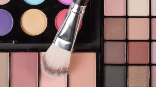 Makeup Brush Over Colorful Palettes Close Up