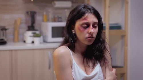 Upset Woman with Bruises in Home Setting