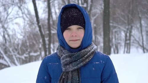 Young Teenage Boy Walks in Winter Forest