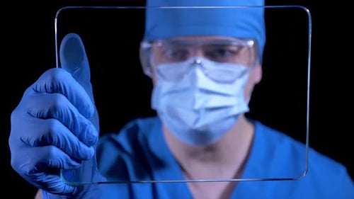 Health Professional Holding Glass Tablet Display