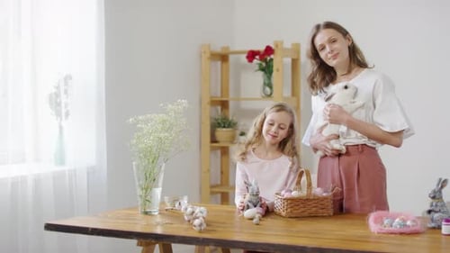 Woman and Girl with Easter Decorations Indoors