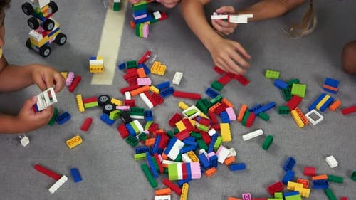 Children Play with Building Blocks Together at Home