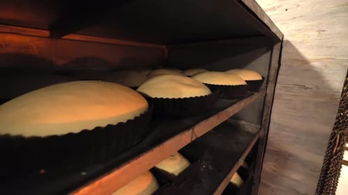 Jars for loaves of raw bread in bakery