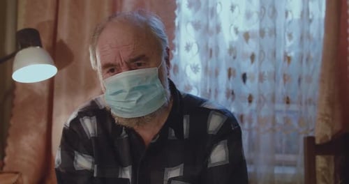 Senior Man Wearing Mask Coughing Inside