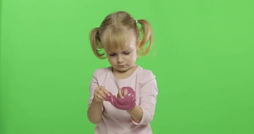 Kid Playing with Hand Made Toy Slime. Child Having Fun Making Pink Slime