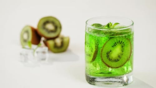 Refreshing Kiwi Drink with Ice Cubes and Bubbles