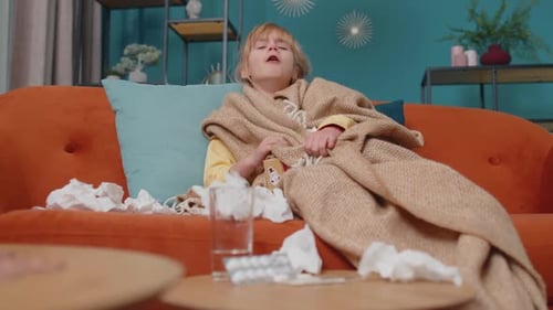 Sick Child Coughs on Couch Indoors