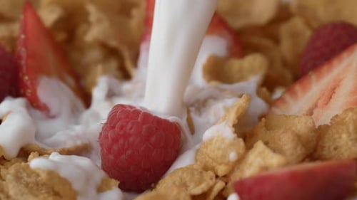 Milk Pouring on Cereal, Strawberries, and Raspberry