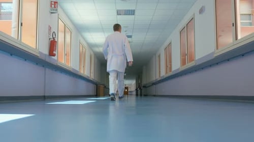 Hospital Hallway With Person Walking Away