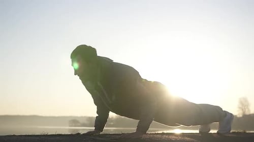 Push ups on the beach early morning at sunrise.