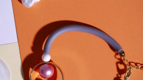 Stylish Gold Jewelry on Orange Background