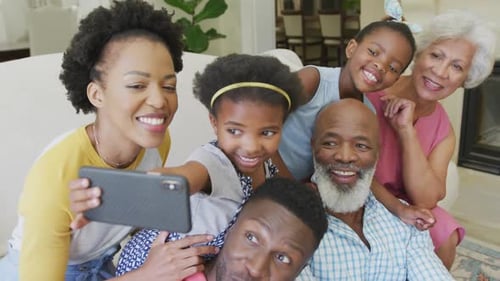 Cheerful Family Taking a Group Selfie at Home