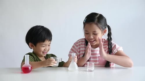 Children Happily Perform Science Experiment Together at Home