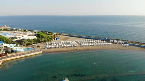 People Bathing in the Sun, Swimming on the Beach. Aerial View of Tourists on the Sand Beach.