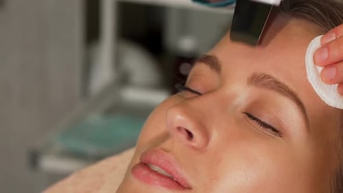 Woman Receiving Facial Treatment in a Clinic