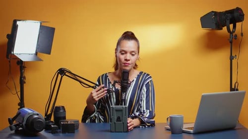 Woman Recording a Video about Camera Equipment