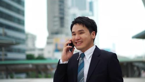 successful business man talking a mobile phone in the city