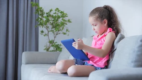 Girl Using Tablet at Home Indoors