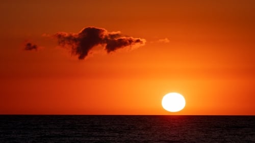 Fiery Sunset Over Calm Ocean Waters