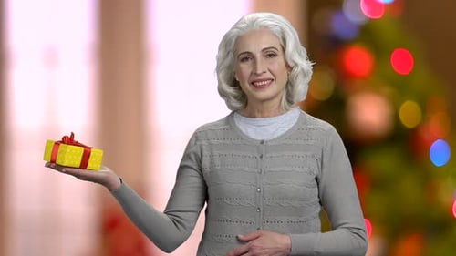 Senior Woman Holding Christmas Gift