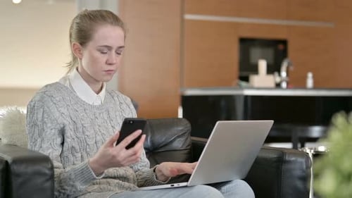 Woman Working on Laptop and Using Smartphone Indoors