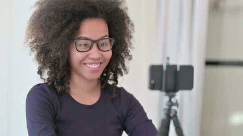 Woman Recording Video Using Smartphone on Tripod
